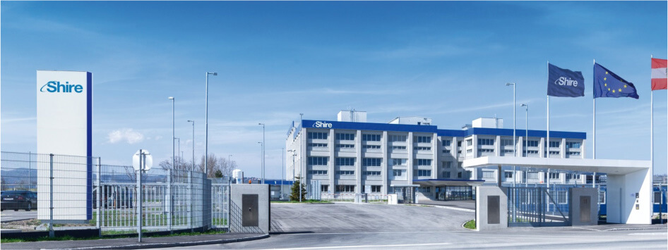 The Shire Krems facility, a blue and white building behind its entrance gate and flagpoles
